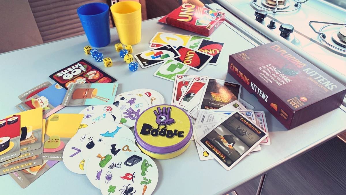 Selection of card and dice games on a campervan table