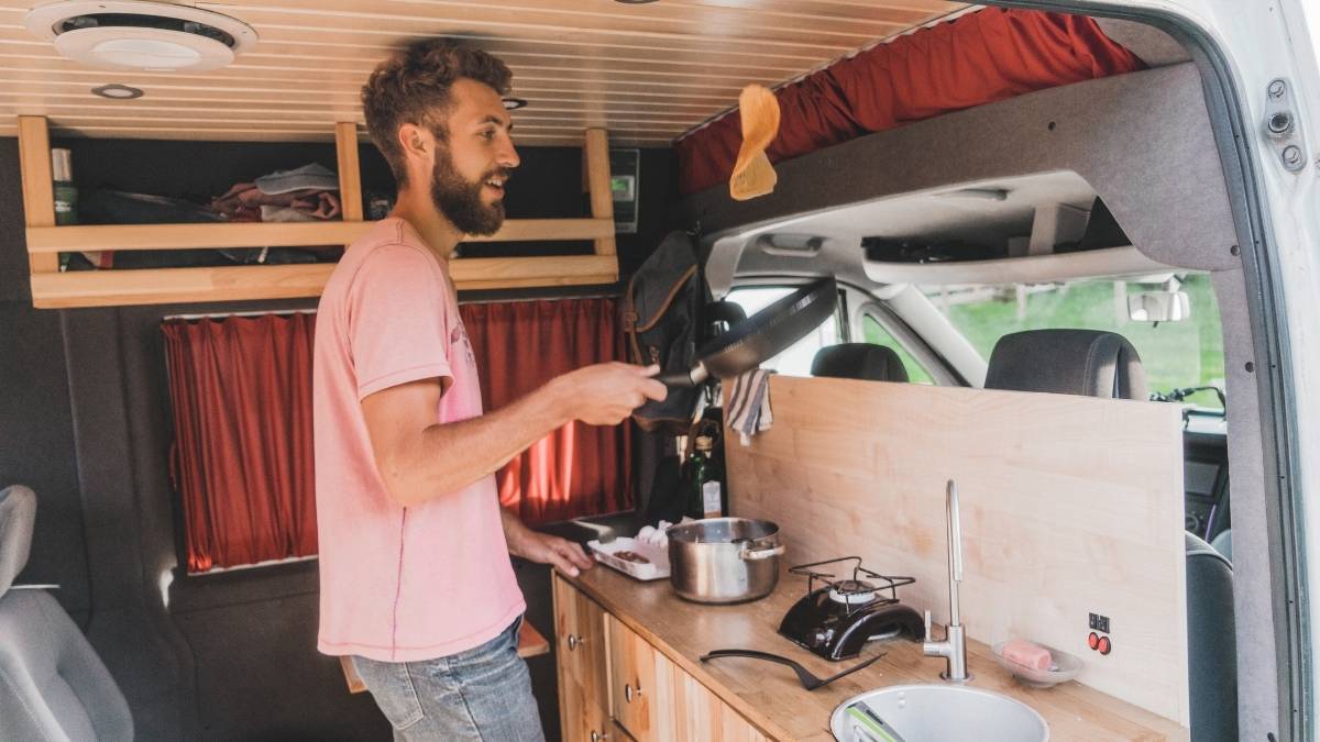 Campervan kitchen essentials - cooking pancakes in a campervan