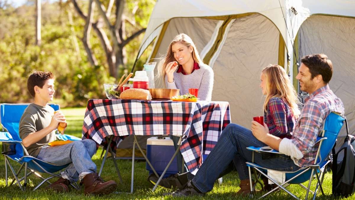 Easy camping meal ideas - family eating hotdogs